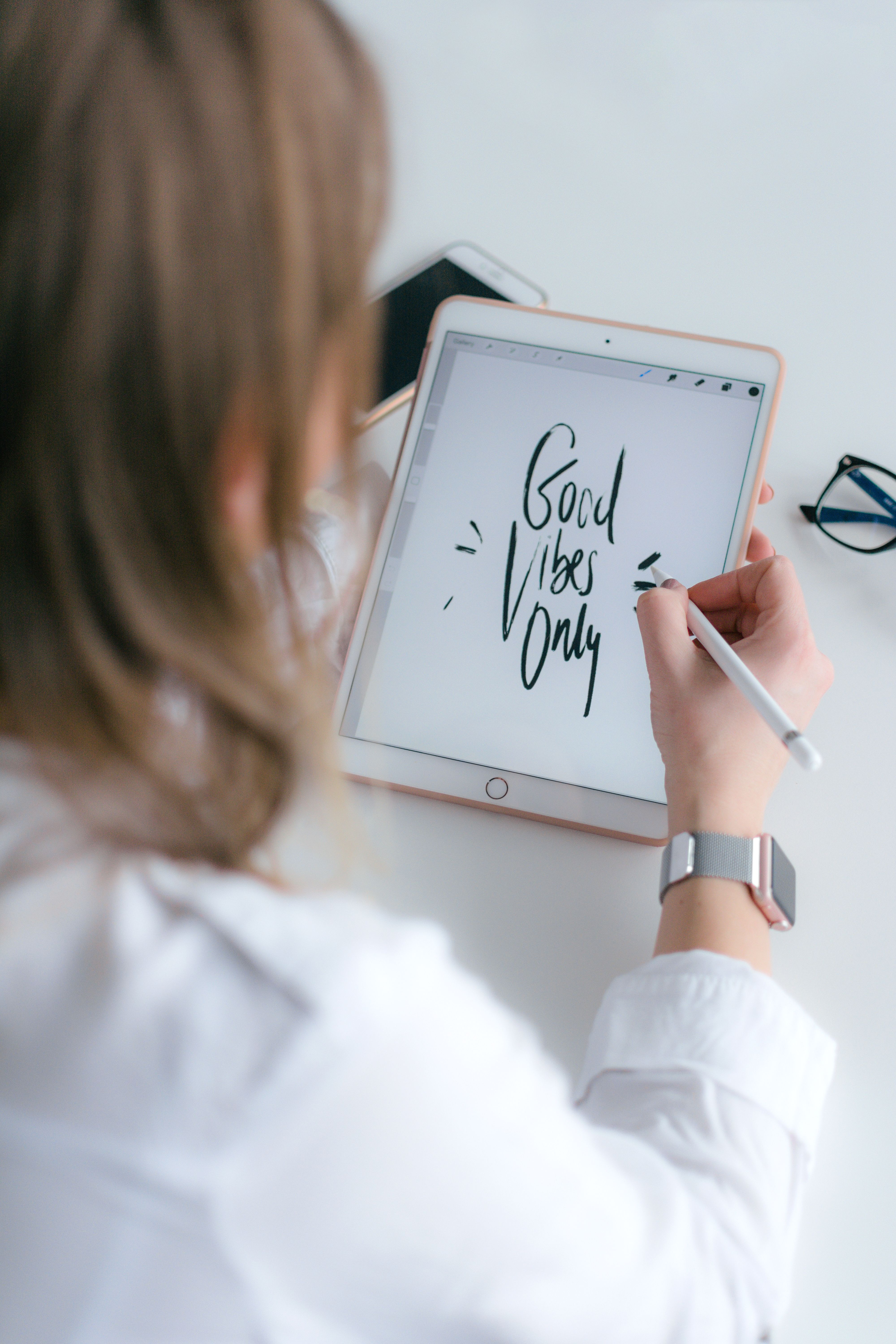 Person using an iPad in a bright, modern space